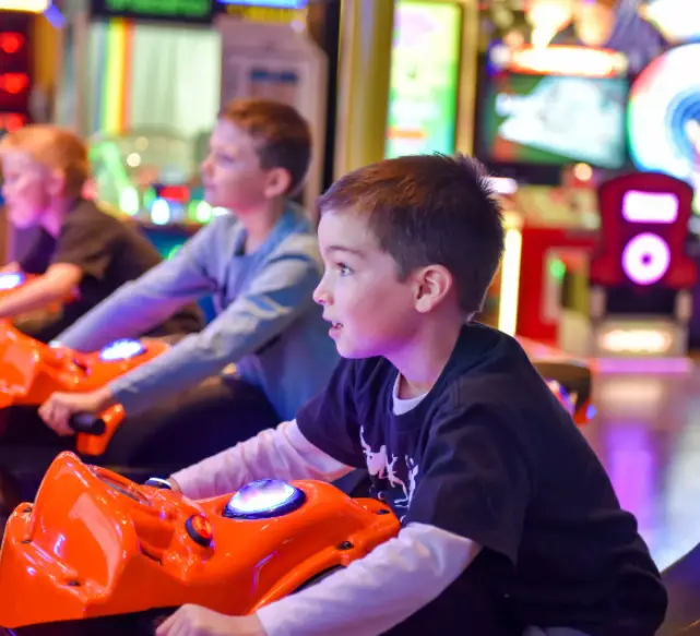 young boy and his friends playing a motorcycle race